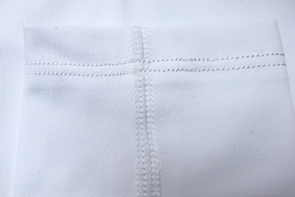 Close up arm sleeve seam showing 4 needle 6 thread construction for durability