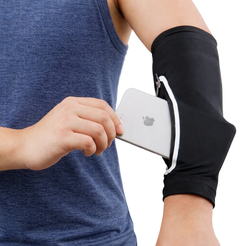 A runner puts a smartphone into their running arm sleeve phone holder