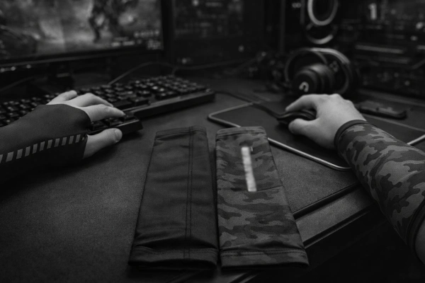 Clean gaming setup with a folded arm sleeve next to mouse and keyboard