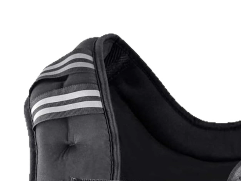 Reflective strips on a weighted vest shoulder strap for visibility