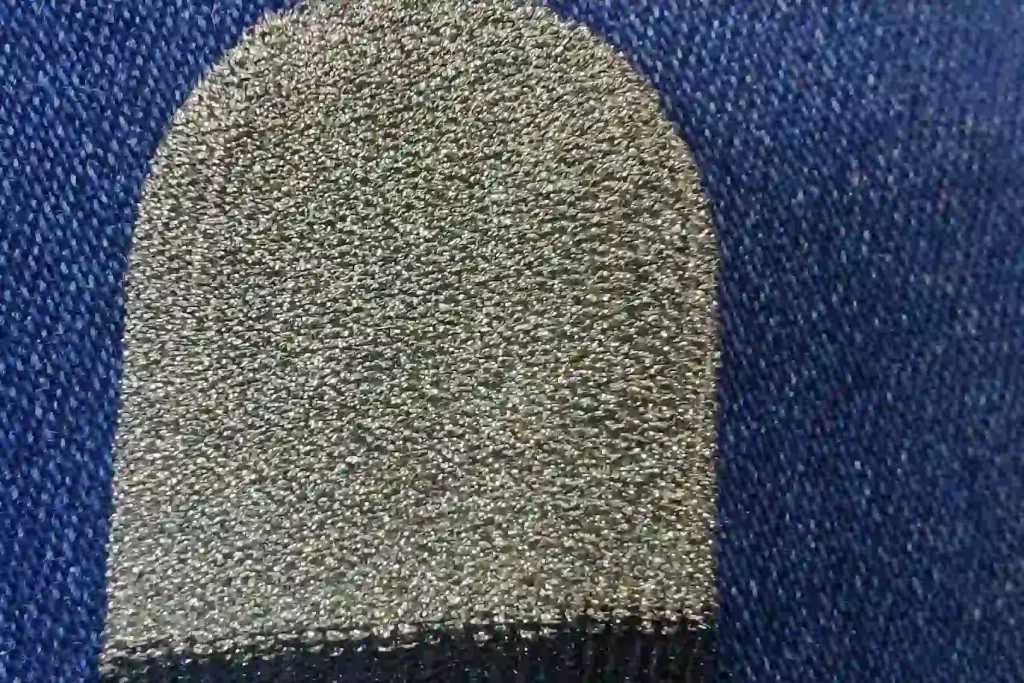 Close-up of worn-out gaming thumb sleeves showing signs of heavy use in mobile competition