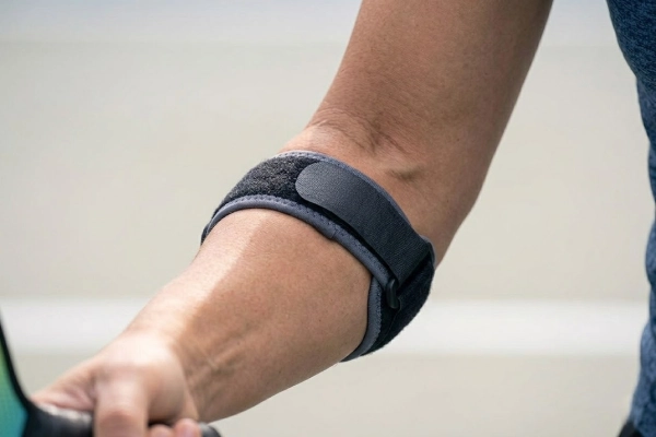 Counterforce pressure_ Close-up of a compression pad in an elbow brace