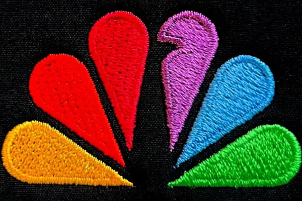 Colorful stitched logo on black fabric showing Embroidery branding technique