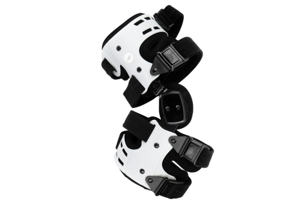 Hinged ACL knee brace with rigid white shell for stabilizing right knee