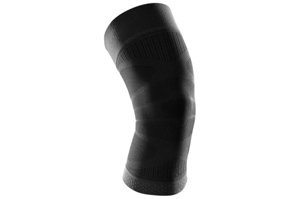 Black knitted Knee Compression Sleeve shown bent at the knee joint
