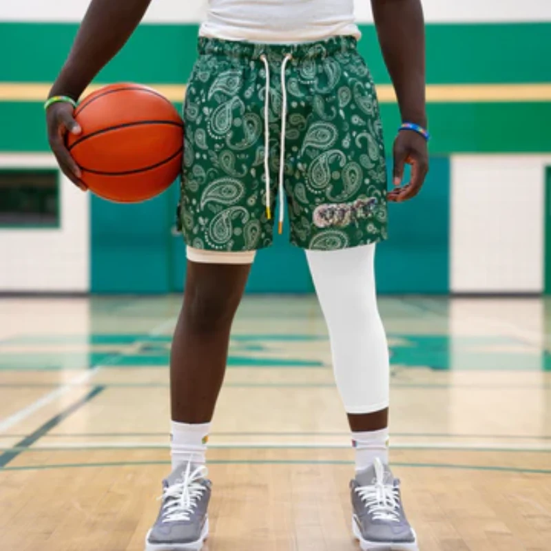 Male player on indoor court showing a white compression basketball leg sleeve
