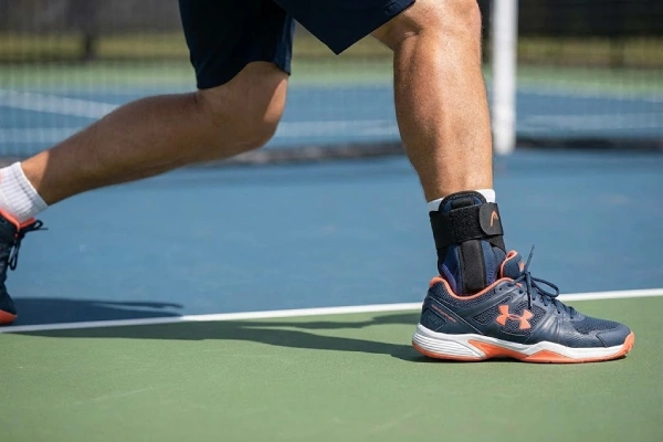 Pickleball ankle brace worn for stability during quick lateral court movements