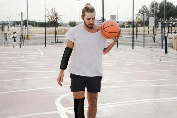 Athlete using gel sleeves for knee and arm support during sports and athletic recovery