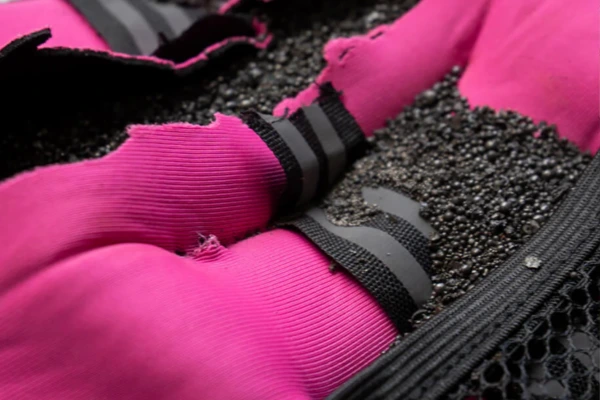 Close-up of iron sand pod filling inside a weighted vest