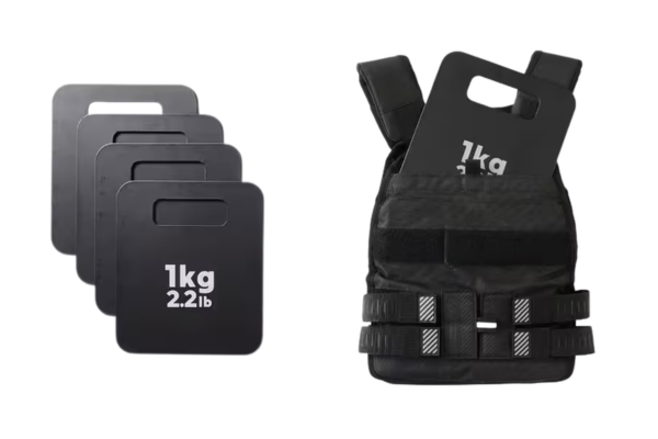 Standard fitness plate weights being loaded into a plate carrier weighted vest